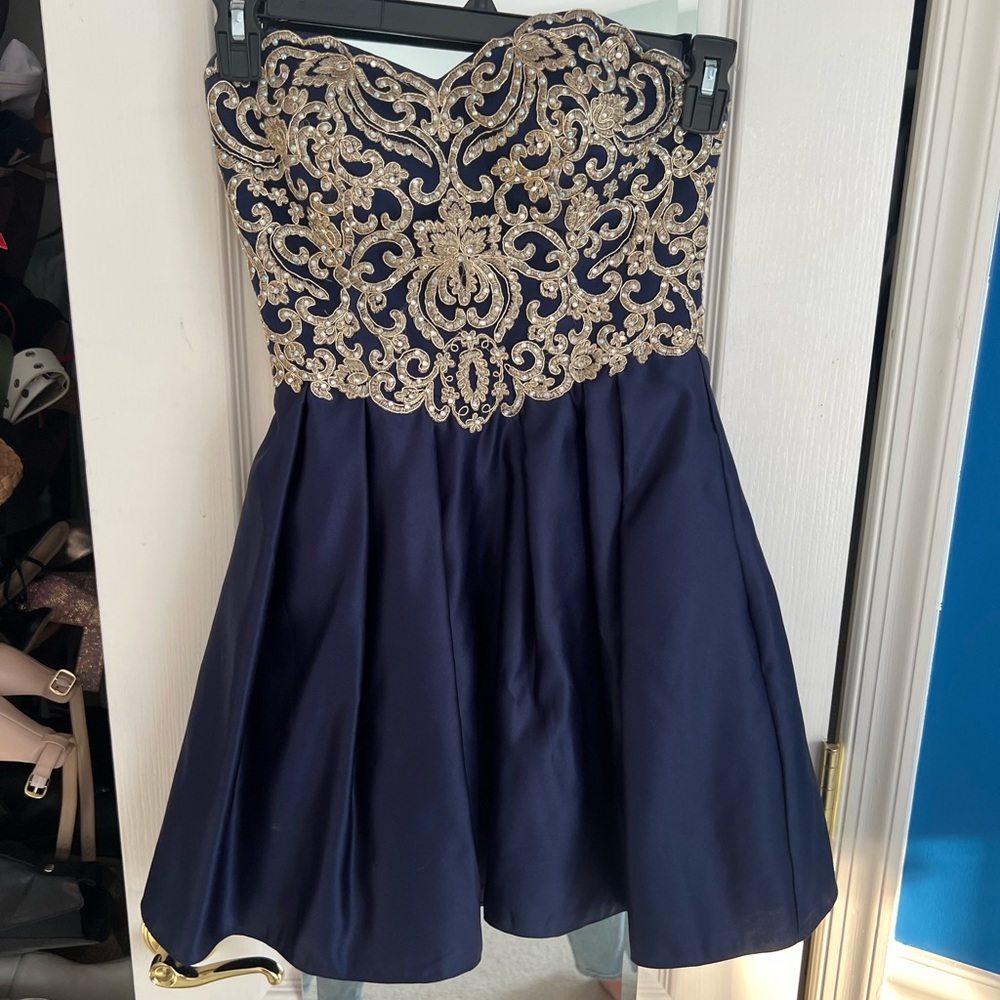 Blue and gold beaded dress with pockets. Sweetheart neckline and corset bodice.